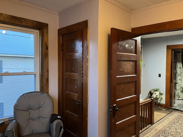 hall featuring light wood-type flooring and ornamental molding