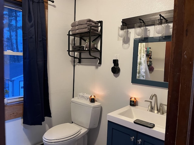 bathroom featuring vanity and toilet