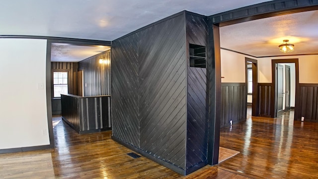 interior space with dark wood-type flooring and ornamental molding