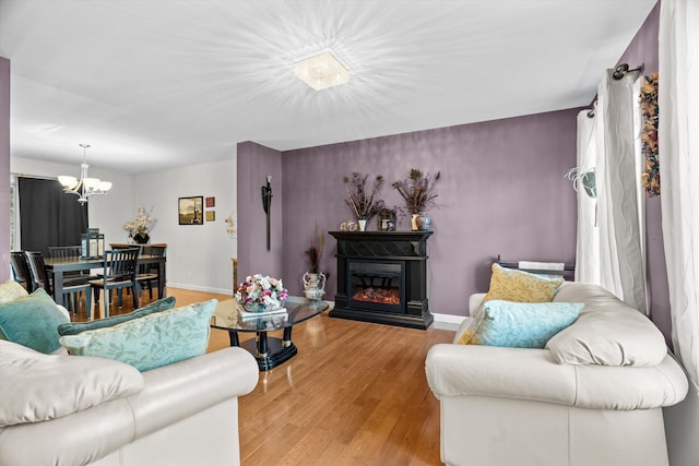 living room featuring light hardwood / wood-style floors and an inviting chandelier