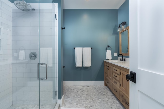 bathroom featuring vanity and a shower with door