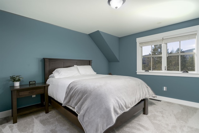 carpeted bedroom featuring lofted ceiling