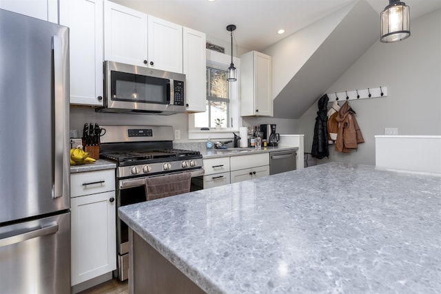 kitchen with appliances with stainless steel finishes, white cabinetry, pendant lighting, and sink