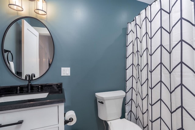 bathroom featuring vanity, a shower with shower curtain, and toilet