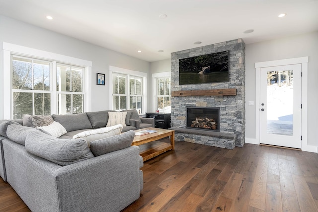 living room featuring a fireplace and dark wood-type flooring