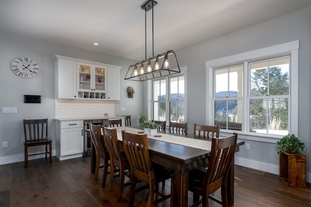 dining space featuring dark hardwood / wood-style floors and a healthy amount of sunlight