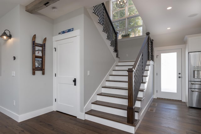 stairway featuring hardwood / wood-style floors and a healthy amount of sunlight