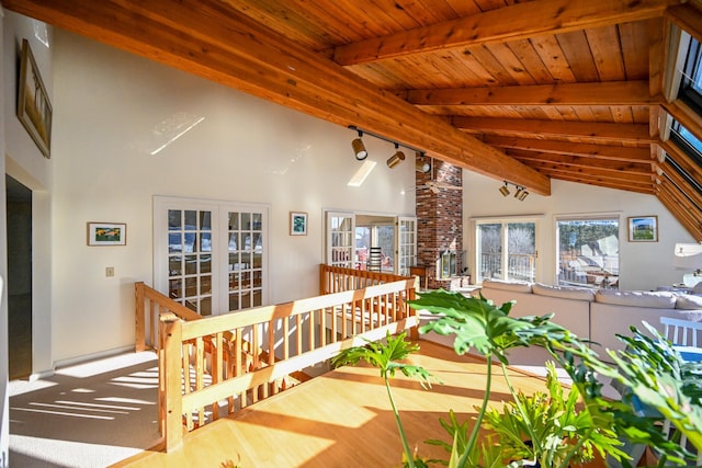 interior space with beam ceiling, french doors, wooden ceiling, high vaulted ceiling, and hardwood / wood-style flooring