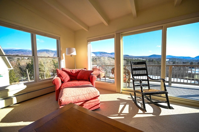 sunroom / solarium with a mountain view, lofted ceiling with beams, and a healthy amount of sunlight