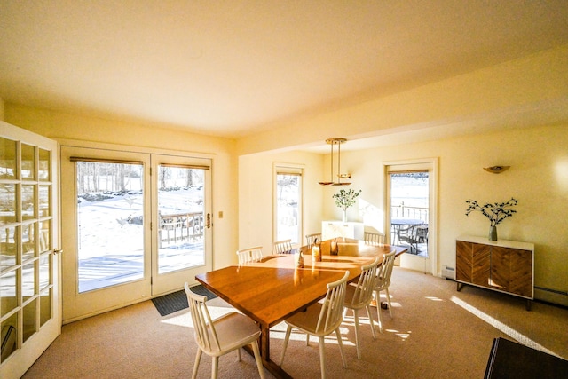 dining space featuring carpet flooring, baseboard heating, and a wealth of natural light