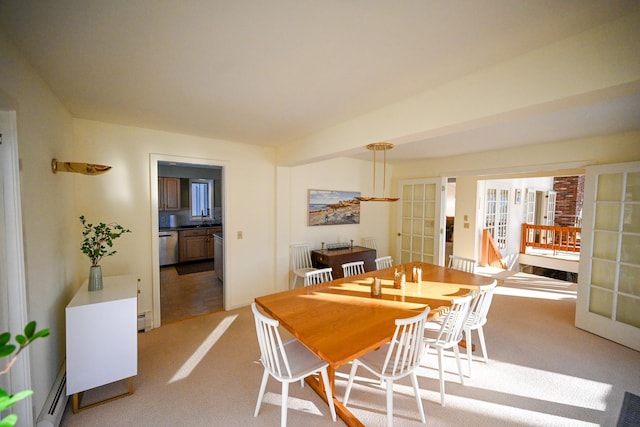 carpeted dining space with french doors and a baseboard radiator