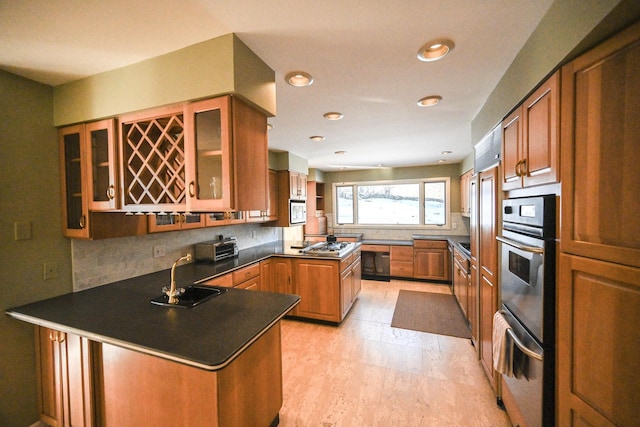 kitchen with sink, black dishwasher, kitchen peninsula, decorative backsplash, and white microwave