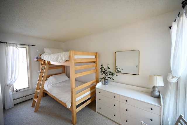 bedroom featuring light carpet, a textured ceiling, and multiple windows