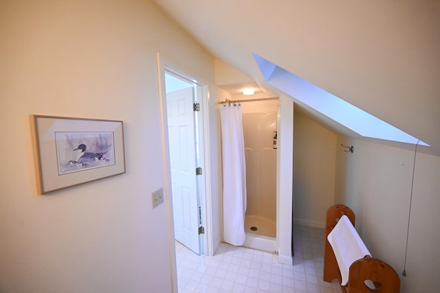 hall featuring vaulted ceiling with skylight