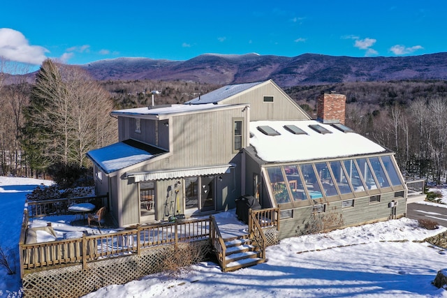 exterior space featuring a deck with mountain view