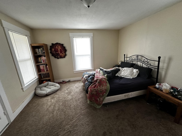 bedroom featuring dark carpet