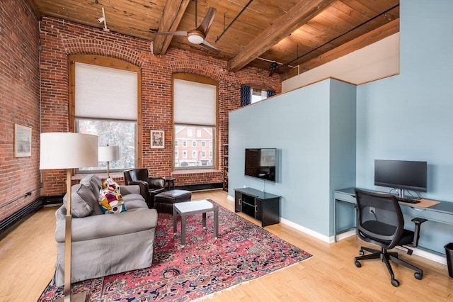 living room with light wood-type flooring, brick wall, wood ceiling, ceiling fan, and beam ceiling