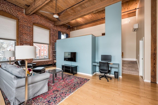 living room with wooden ceiling, ceiling fan, beam ceiling, light hardwood / wood-style floors, and brick wall