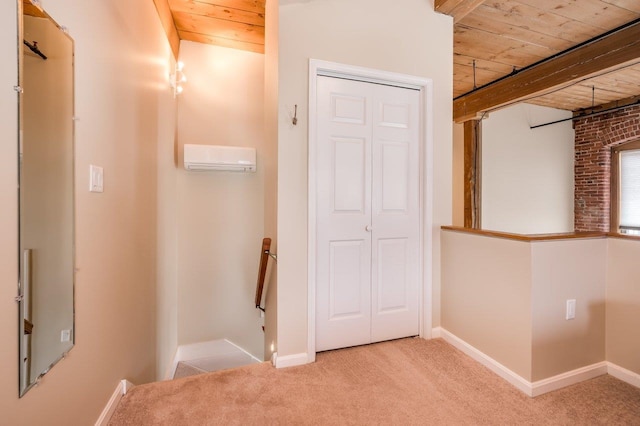 hallway with beamed ceiling, light colored carpet, wood ceiling, and a wall mounted AC