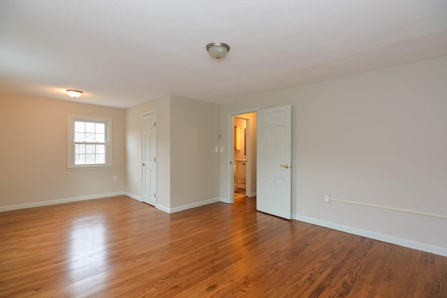 empty room with hardwood / wood-style flooring