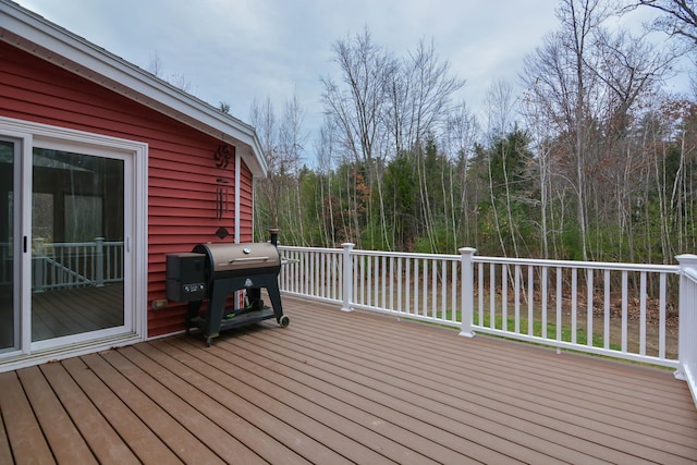 wooden deck featuring a grill