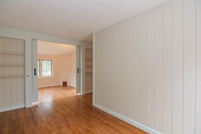 empty room with hardwood / wood-style floors