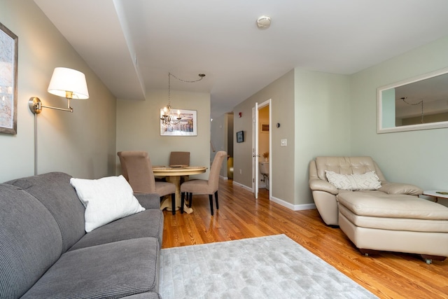 living room featuring light hardwood / wood-style flooring and a notable chandelier