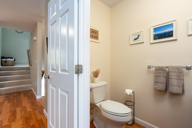 bathroom featuring toilet and wood-type flooring