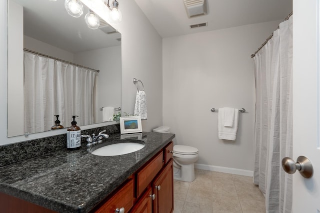 bathroom featuring tile patterned floors, vanity, and toilet