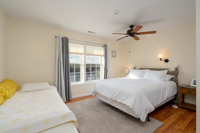 bedroom with hardwood / wood-style floors and ceiling fan