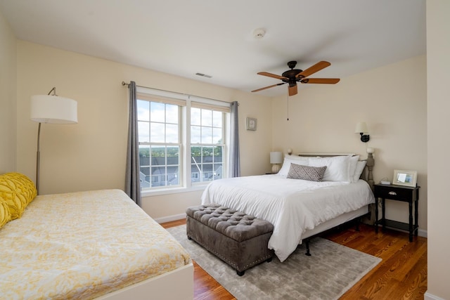 bedroom with ceiling fan and dark hardwood / wood-style flooring