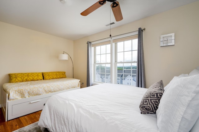 bedroom featuring ceiling fan and dark wood-type flooring