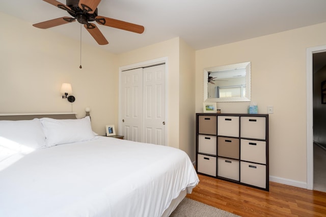 bedroom with ceiling fan, light wood-type flooring, and a closet