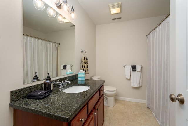 bathroom with tile patterned floors, vanity, and toilet