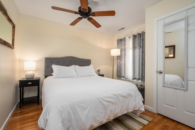 bedroom with ceiling fan and wood-type flooring