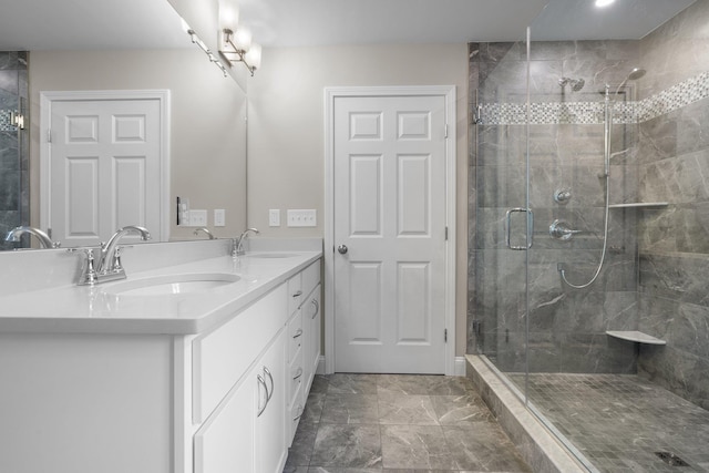 bathroom with vanity and a shower with door