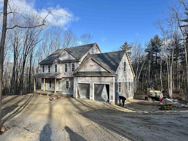 view of front of home featuring a porch and a garage