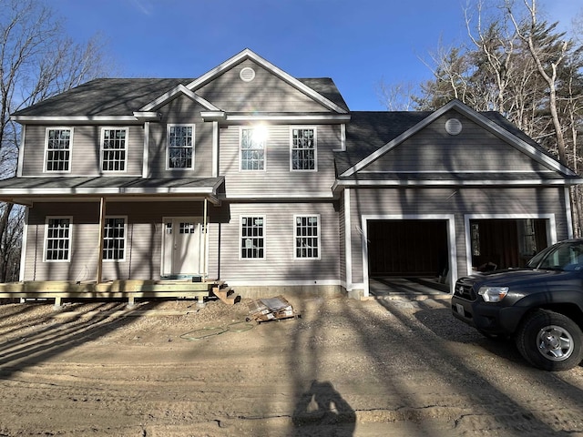 view of front facade featuring a porch and a garage