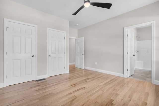 unfurnished bedroom with connected bathroom, ceiling fan, and light wood-type flooring