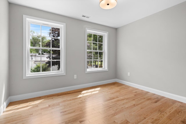 unfurnished room with light hardwood / wood-style floors