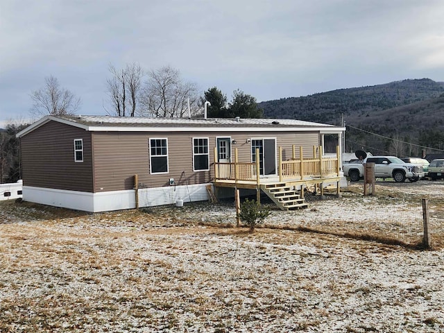 exterior space featuring a deck with mountain view