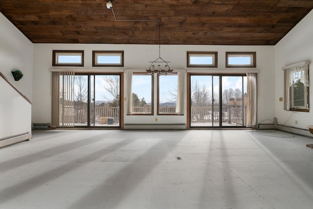 unfurnished living room with baseboard heating, a towering ceiling, wood ceiling, and an inviting chandelier