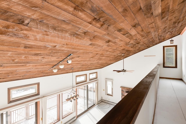 corridor with baseboard heating, track lighting, wood ceiling, and vaulted ceiling