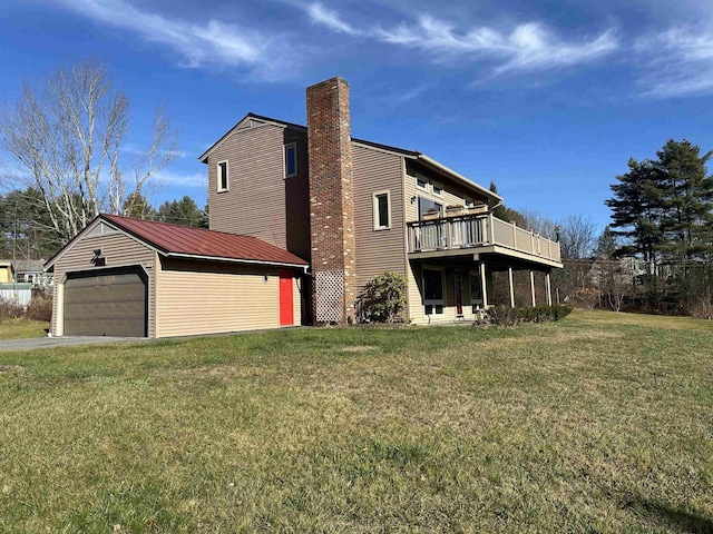 view of side of property with a lawn, a deck, and a garage