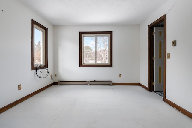 empty room featuring plenty of natural light and a baseboard heating unit