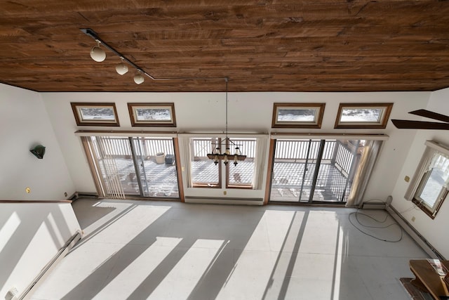 interior space featuring track lighting, a baseboard heating unit, an inviting chandelier, light tile patterned flooring, and wood ceiling