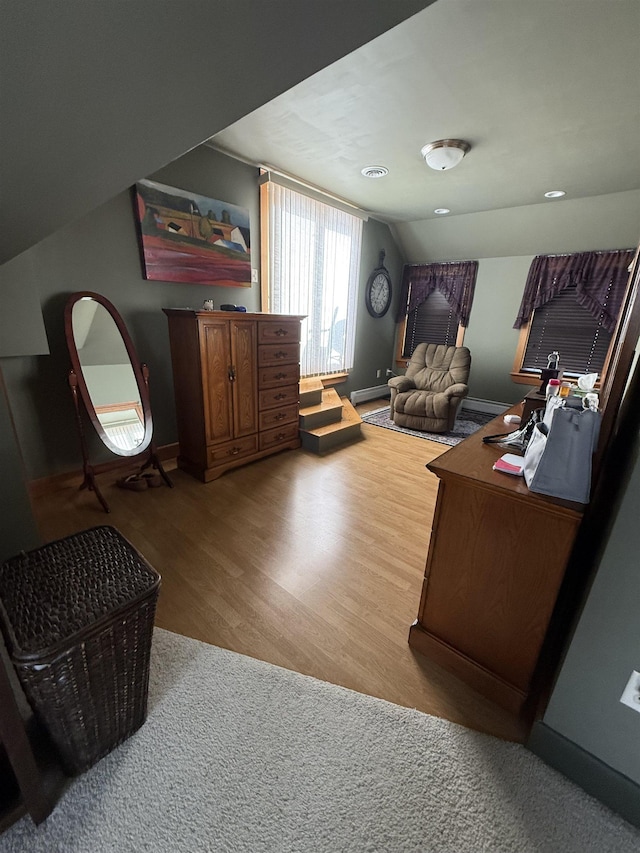 home office with vaulted ceiling and wood-type flooring