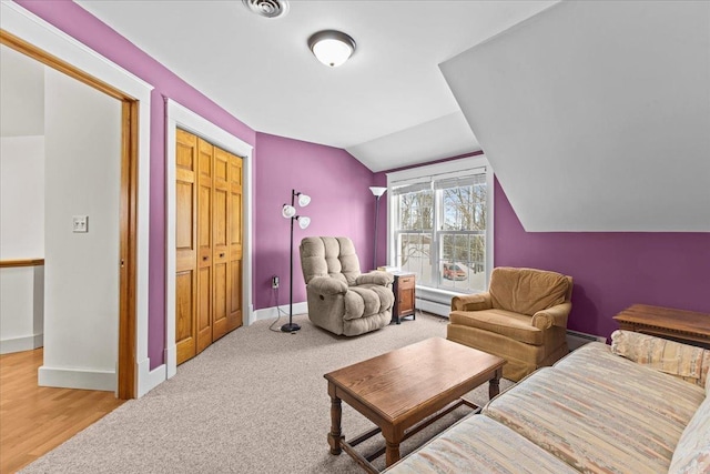 sitting room featuring a baseboard radiator, carpet, and vaulted ceiling