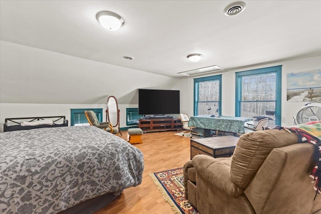 bedroom featuring hardwood / wood-style floors and vaulted ceiling