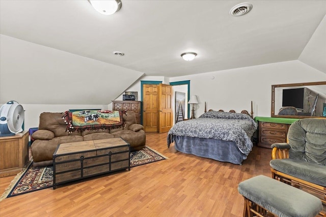 bedroom featuring wood-type flooring and vaulted ceiling